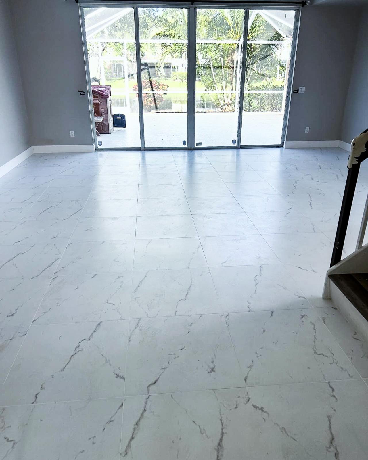 Living space with new marble-look tile flooring after carpet removal